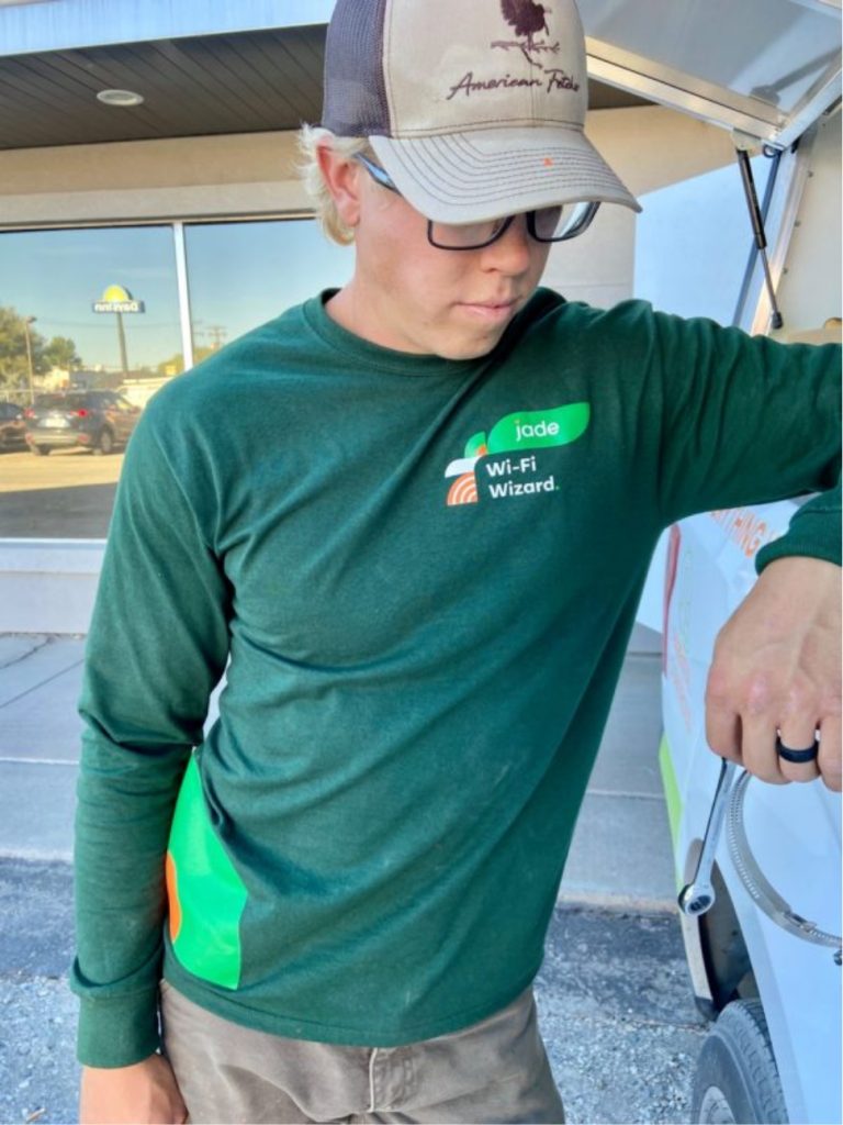 A Prime Connect employee wearing a "Wi-Fi Wizard" shirt.